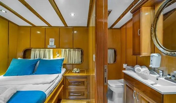Double cabin aboard Tersane 8 yacht with beds, wood interior, and ensuite area