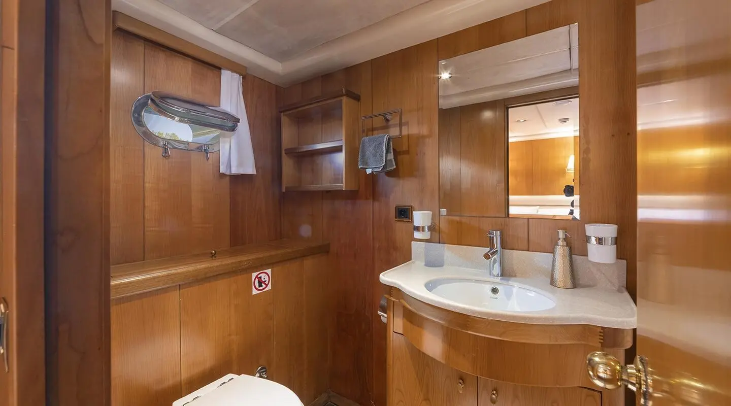 Interior of Queen Of Sea luxury yacht with wood-paneled walls and minibar
