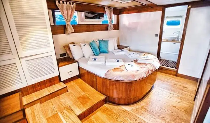 Maske 2 master cabin with king bed, surrounding wood accents, en suite feel