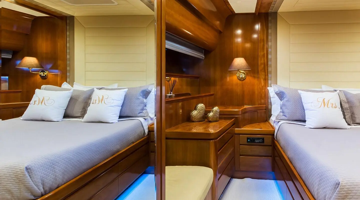 Interior view of Amoraki yacht cabin with wooden panels and bed