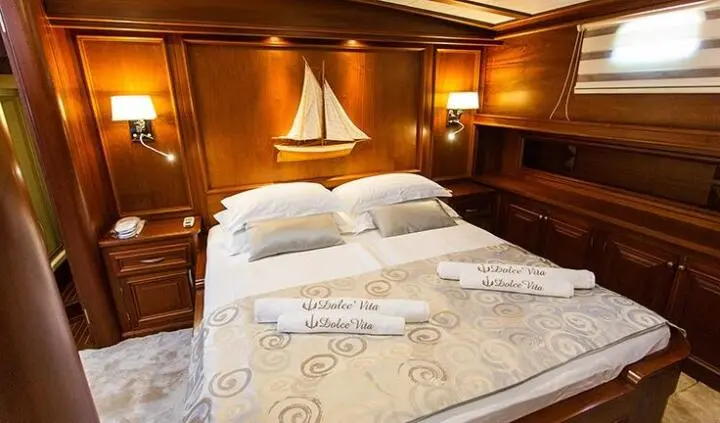 Dolce Vita master cabin with king bed, ensuite bathroom visible