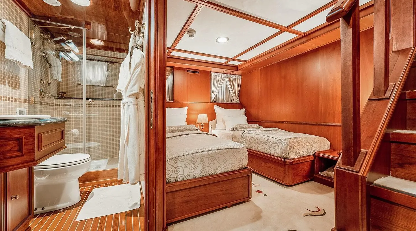 Interior of Seagull II yacht with a wooden cabin, bed, and seating area