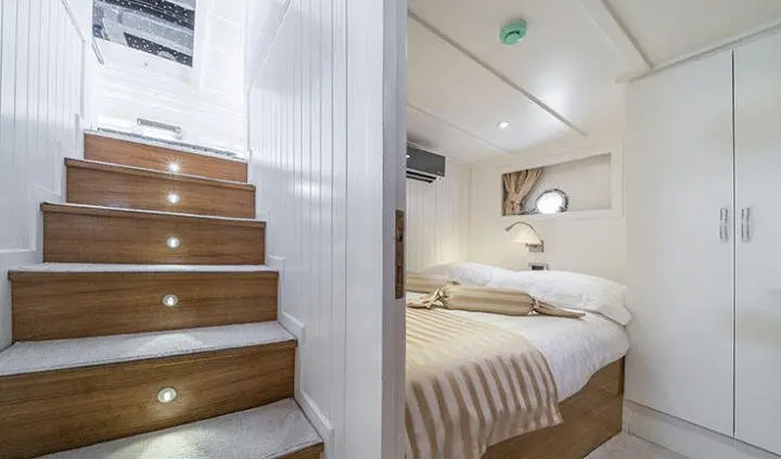 Maske yacht master cabin with king bed, ensuite, visible stairs and seating