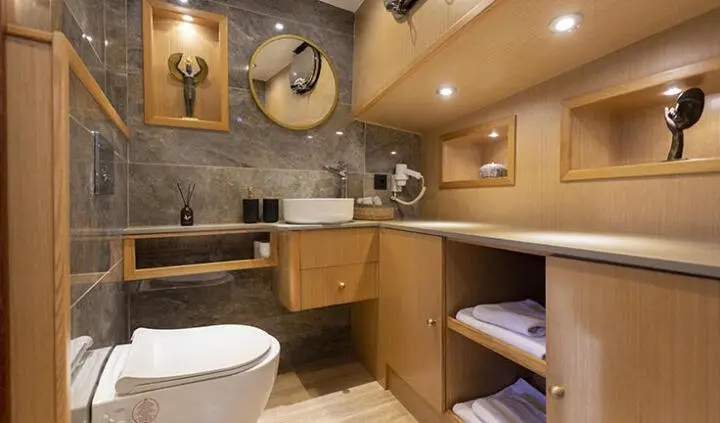 Diva Deniz master cabin ensuite with bed, seating, and bathroom area visible