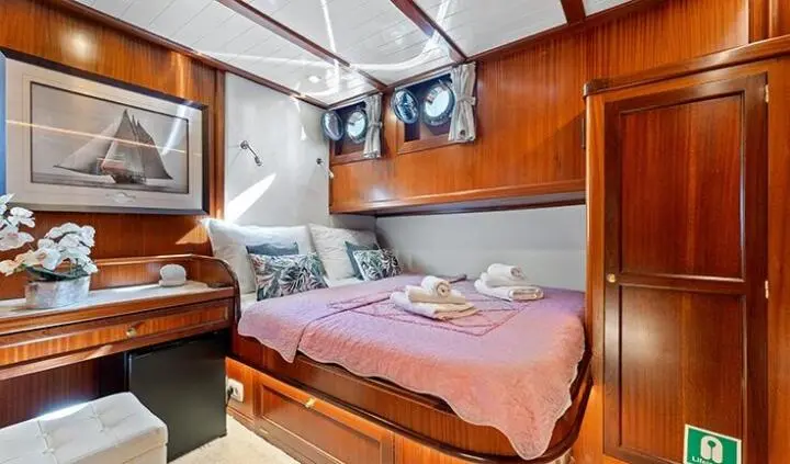 Smart Spirit cabin with a large bed, wooden cabinetry, and ensuite bathroom door