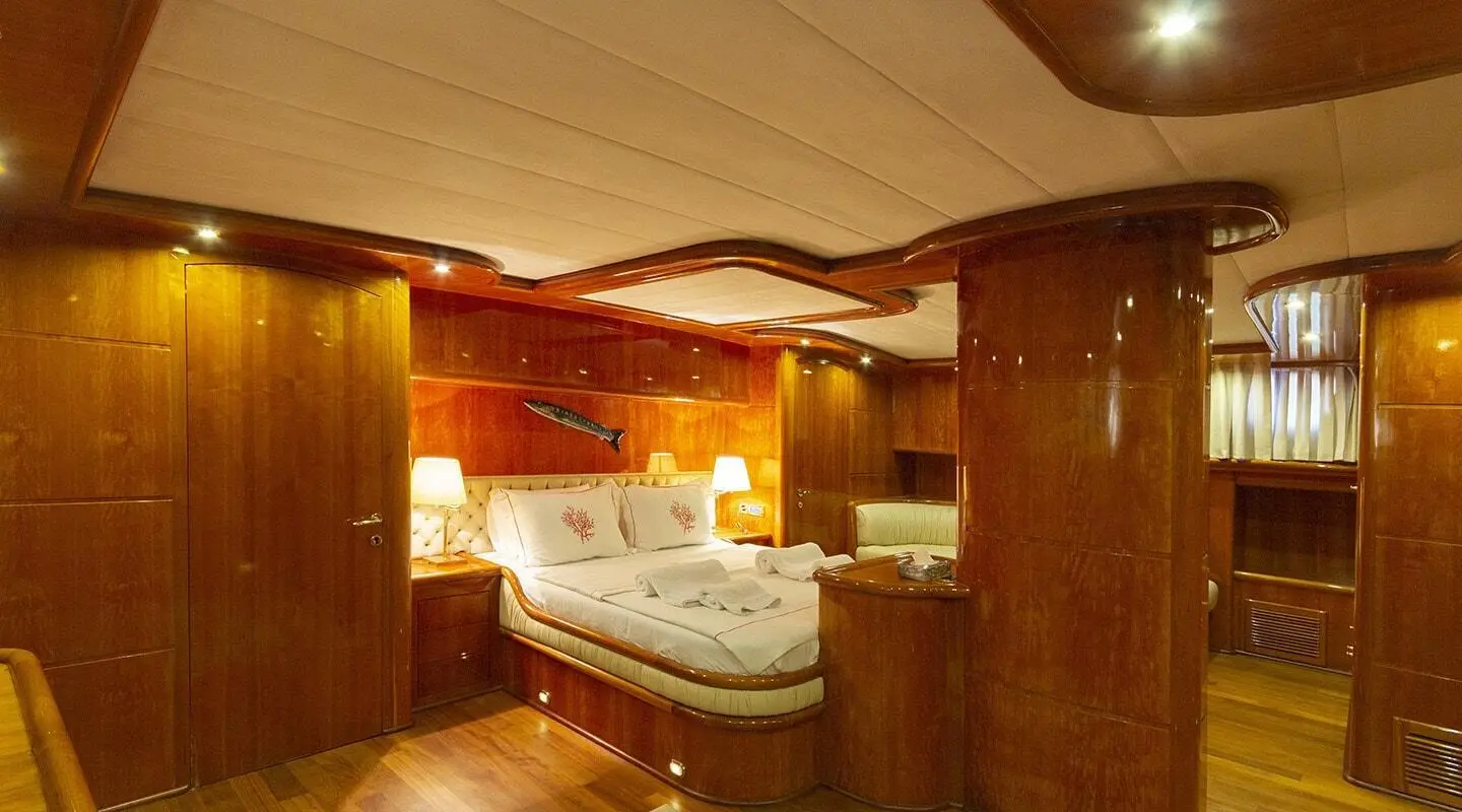 Elegant luxury yacht interior with bathtub, wood paneling, and warm lighting