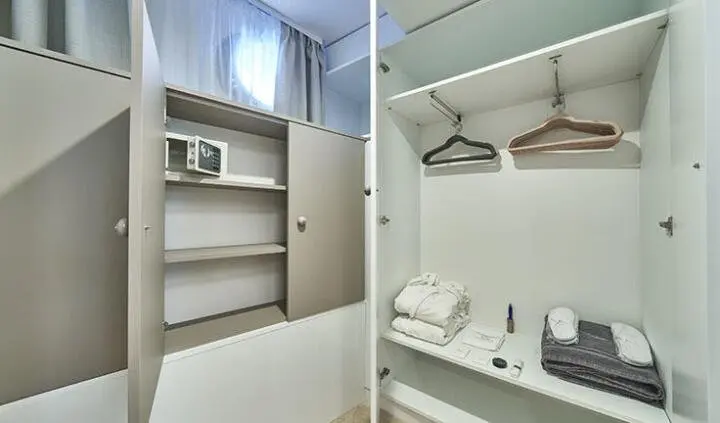 Compact yacht cabin wardrobe and ensuite with open shelves and hanging space