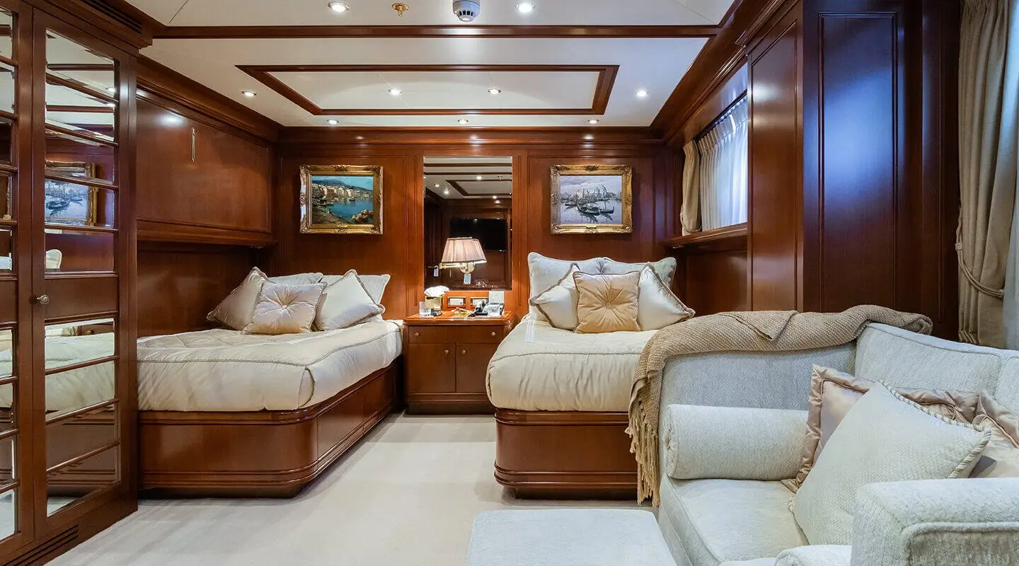 Apogee yacht interior with plush seating and wood paneling in a luxurious cabin
