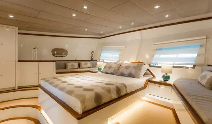 Interior of Grand Sailor yacht cabin with two large beds and portholes