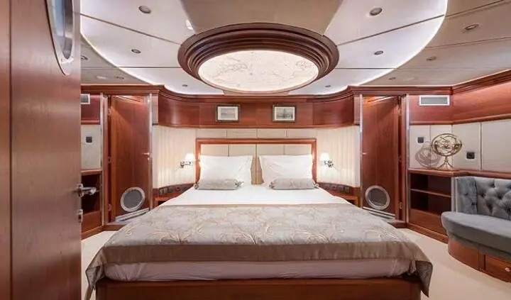 Lady Gita master cabin with king bed and ensuite, warm wood paneling