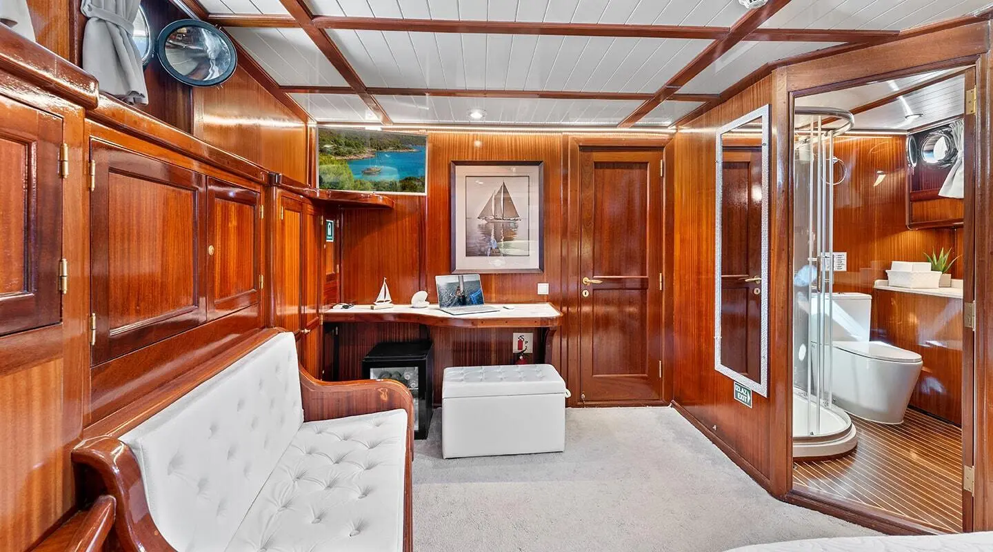 Luxurious yacht interior with wooden paneling, leather seating, and soft lighting at sunset