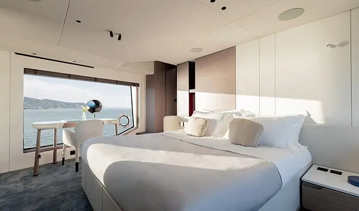 Master cabin with king bed and ensuite, large windows and soft lighting