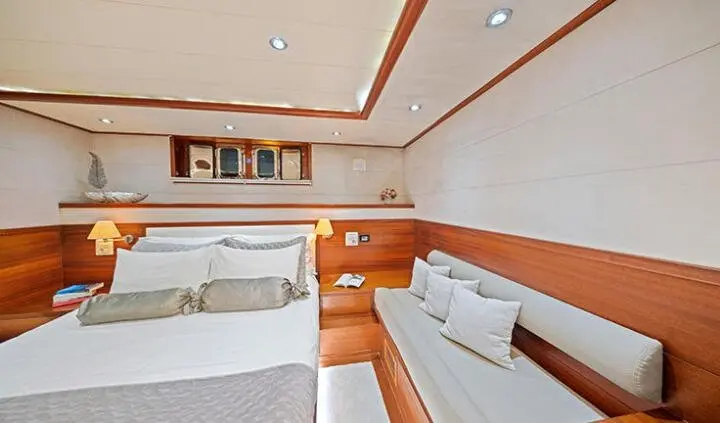 Master cabin with two single beds and ensuite area, wood accents