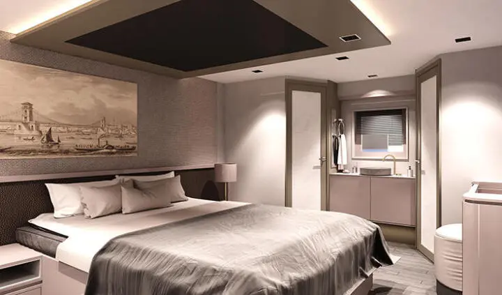 Twin cabin with two beds, shared ensuite, porthole light, wood tones