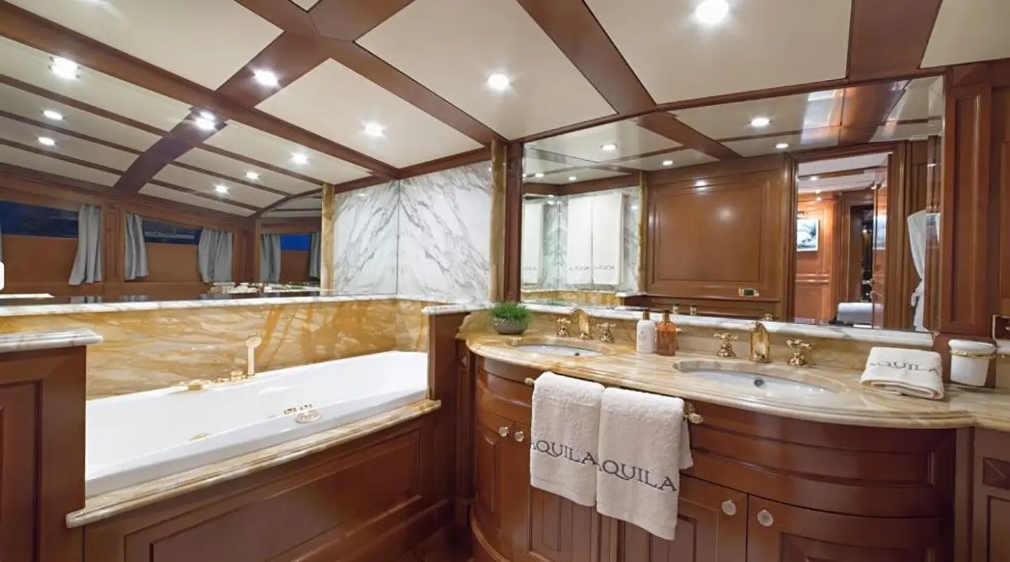 Interior of Aquila luxury motor yacht with wood paneling and seating area