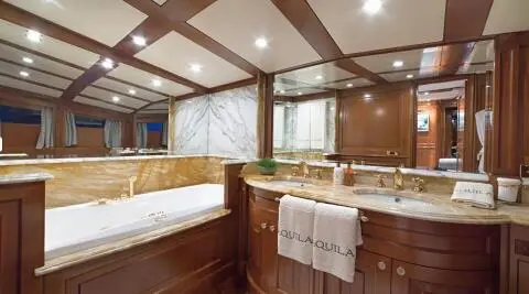 Interior of Aquila luxury motor yacht with wood paneling and seating area