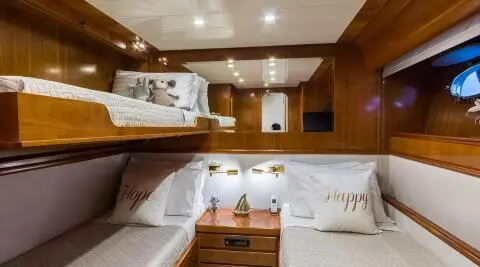 Interior of Amoraki yacht lounge with white seating and wooden accents
