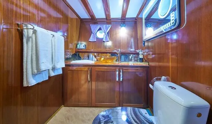 Stella Maris master cabin with king bed, wood paneling, windows, and ensuite area
