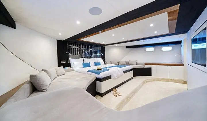 Master cabin with king bed, white decor, seating area, and ensuite