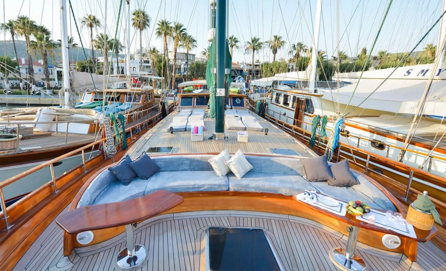 Wide deck with wood yacht seating area and cushions