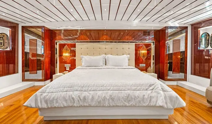 Esma Sultan master cabin with king bed, white linens, wooden headboard