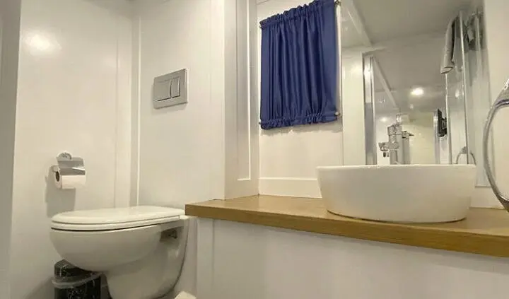 Maske 5 master cabin with king bed and ensuite visible through windowed counter