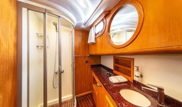 Mein Schatz master cabin with king bed, wooden cabinetry, and ensuite shower