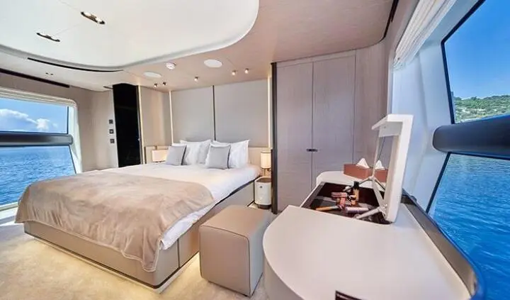 Master cabin with king bed, ensuite, light wood tones and seating area