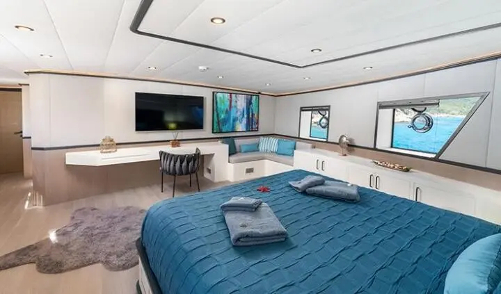 Calm Down master cabin with king bed, ensuite, blue bedding and seating area