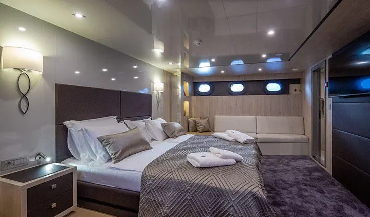 Master cabin on Dalmatino yacht with king bed and ensuite visible