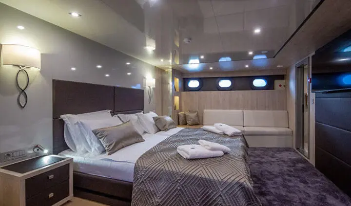 Master cabin on Dalmatino yacht with king bed and ensuite visible