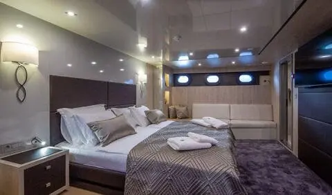 Master cabin on Dalmatino yacht with king bed and ensuite visible