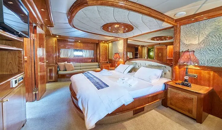 Master cabin with king bed, ensuite, wood paneling, blue and white linens