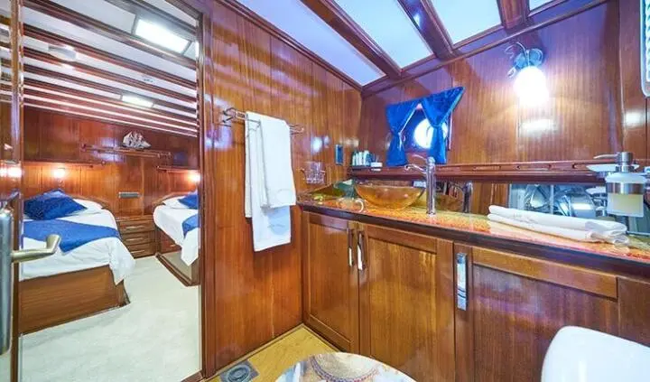 Stella Maris master cabin with king bed, ensuite, wood paneling and large window