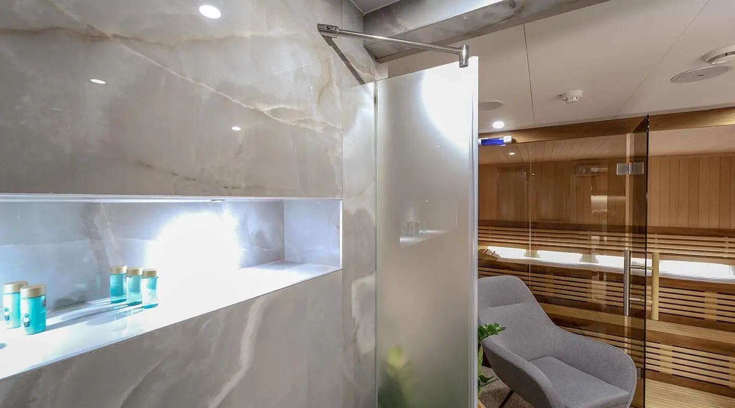 Luxurious yacht interior with a frosted glass door, modern decor, and seating area