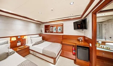 Twin cabin with king-size bed, wooden cabinetry, and ceiling lights