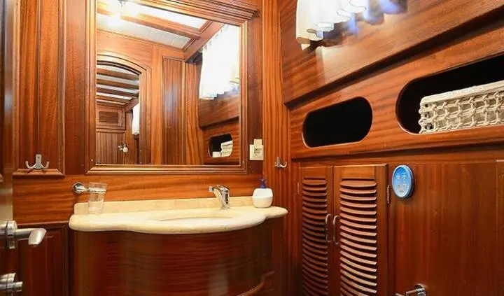 Zephyria II cabin ensuite with wooden paneling, mirror, and sink area