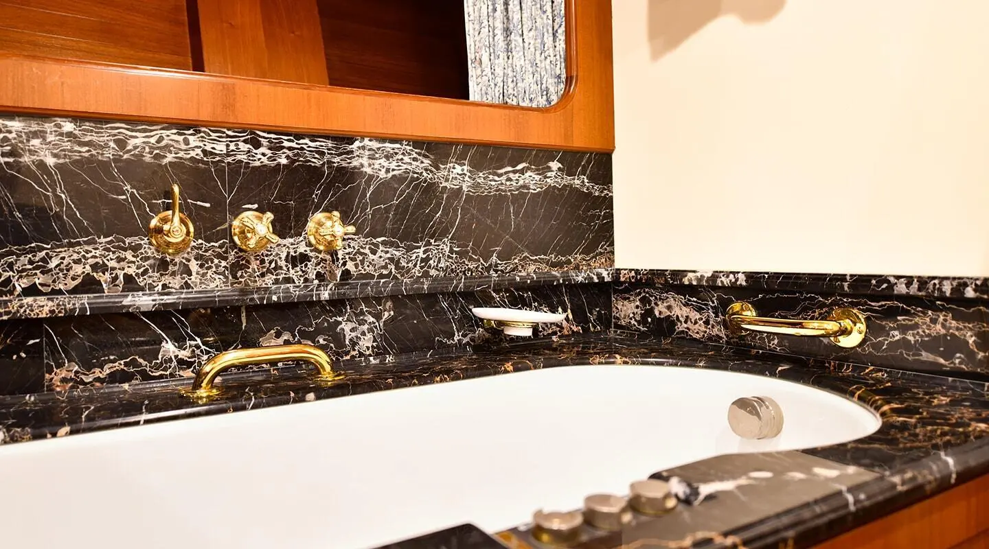 Tamarita luxury yacht bathroom with marble countertop and sink.