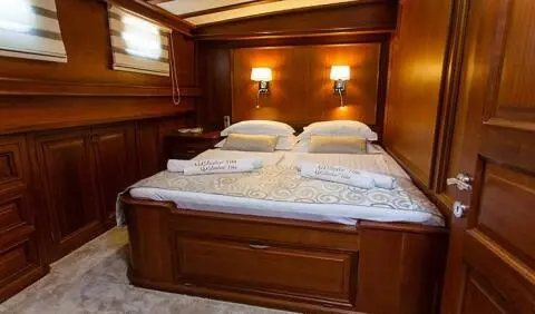Dolce Vita master cabin with king bed and ensuite visible in wood-paneled room