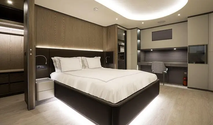 Luxurious master cabin on Good Life yacht with king bed, ambient lighting
