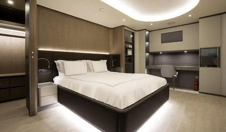 Luxurious master cabin on Good Life yacht with king bed, ambient lighting