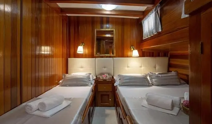 Twin cabin with ensuite bathroom on yacht Andi Star, wood paneling interior