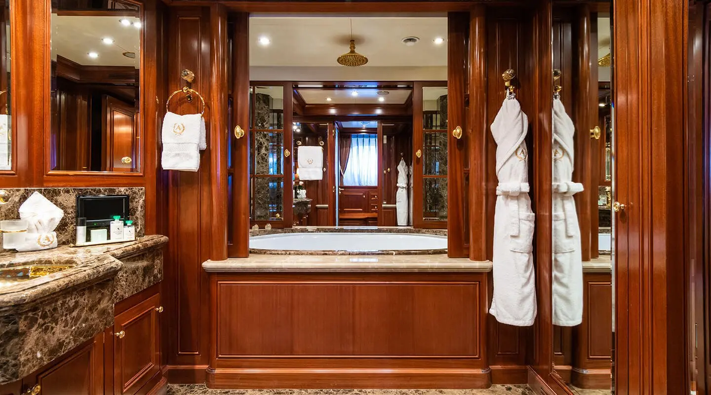 Luxurious yacht bathroom with polished wood panels and a mirror