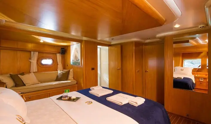 Master cabin with king bed, wood paneling, ensuite and nightstands