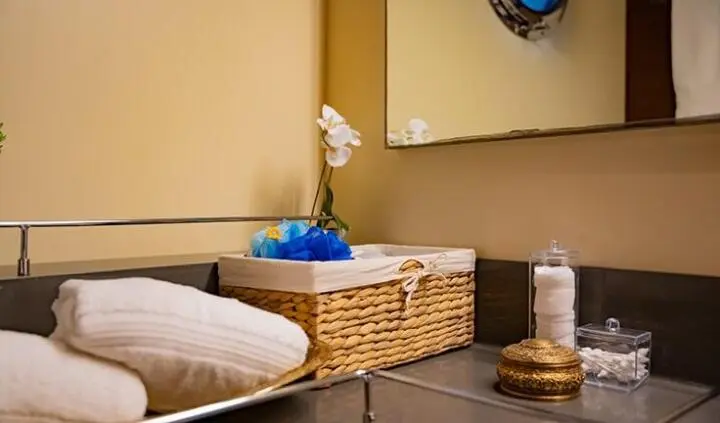 Master cabin with king bed, wood tones, basket storage and blue decor