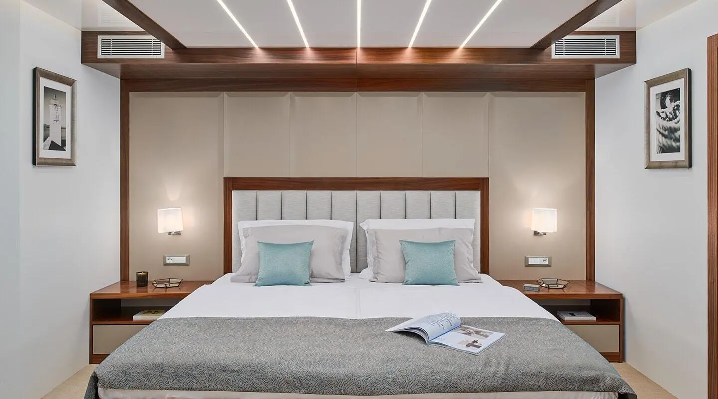 Corsario yacht upscale bedroom interior with a large bed and pillows