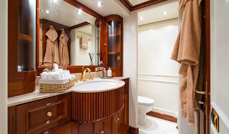 Amadea yacht master cabin with king bed, wood cabinetry, ensuite bathroom