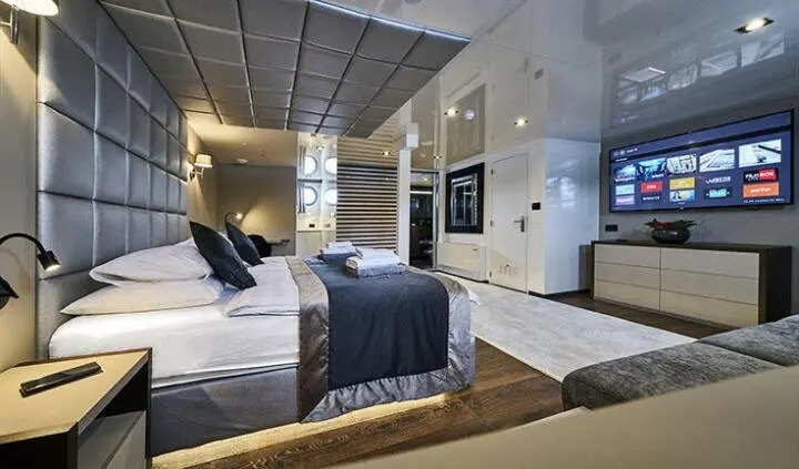 Master cabin with king bed, ensuite, navy bedding and luxury decor