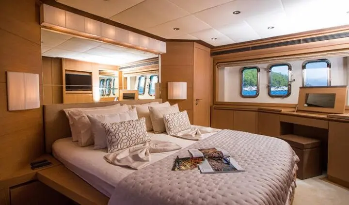 Master cabin on Salt yacht with king bed, ensuite and soft lighting