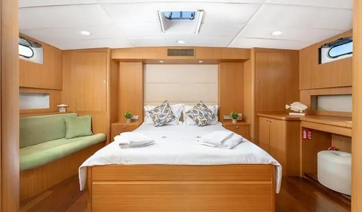 Artemis yacht master cabin with queen bed and wood cabinetry